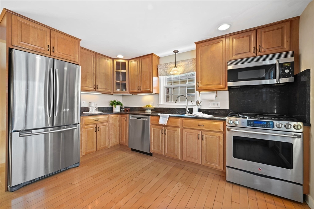 48 Grapevine Avenue Lexington, MA 02421 - Photo 12 of 34 a kitchen with granite countertop a refrigerator stove and microwave
