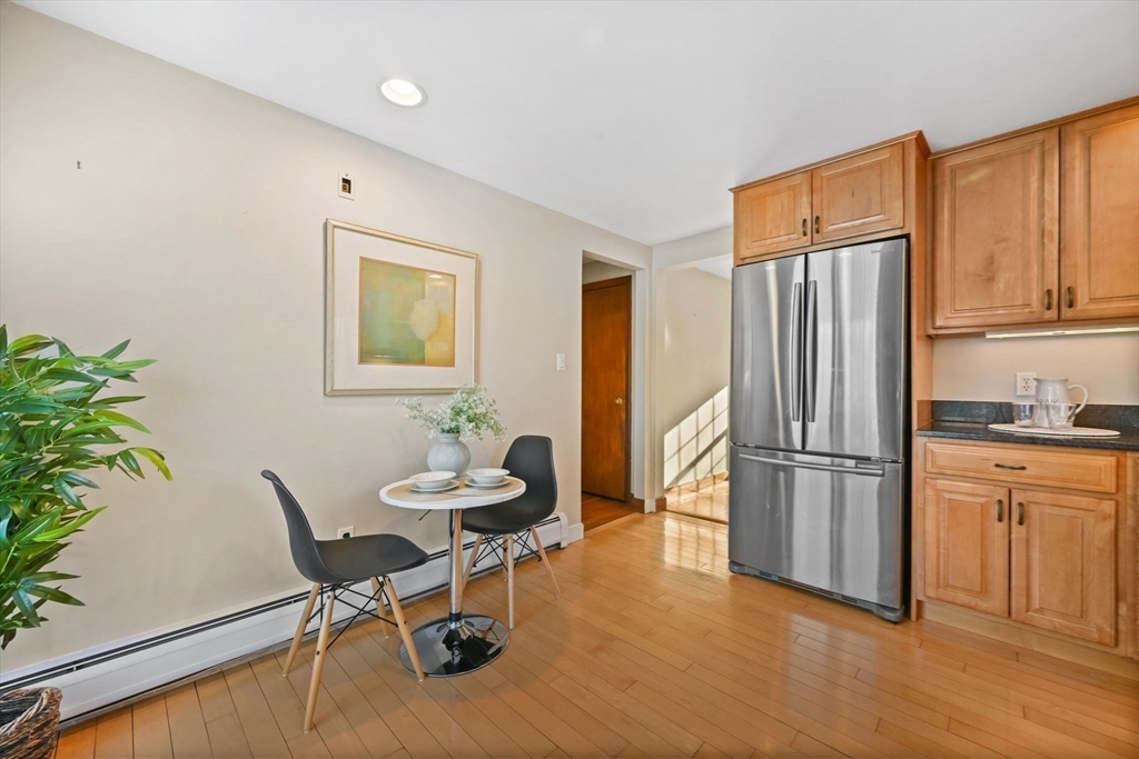 48 Grapevine Avenue Lexington, MA 02421 - Photo 15 of 34 a kitchen with stainless steel appliances granite countertop a refrigerator and a stove top oven