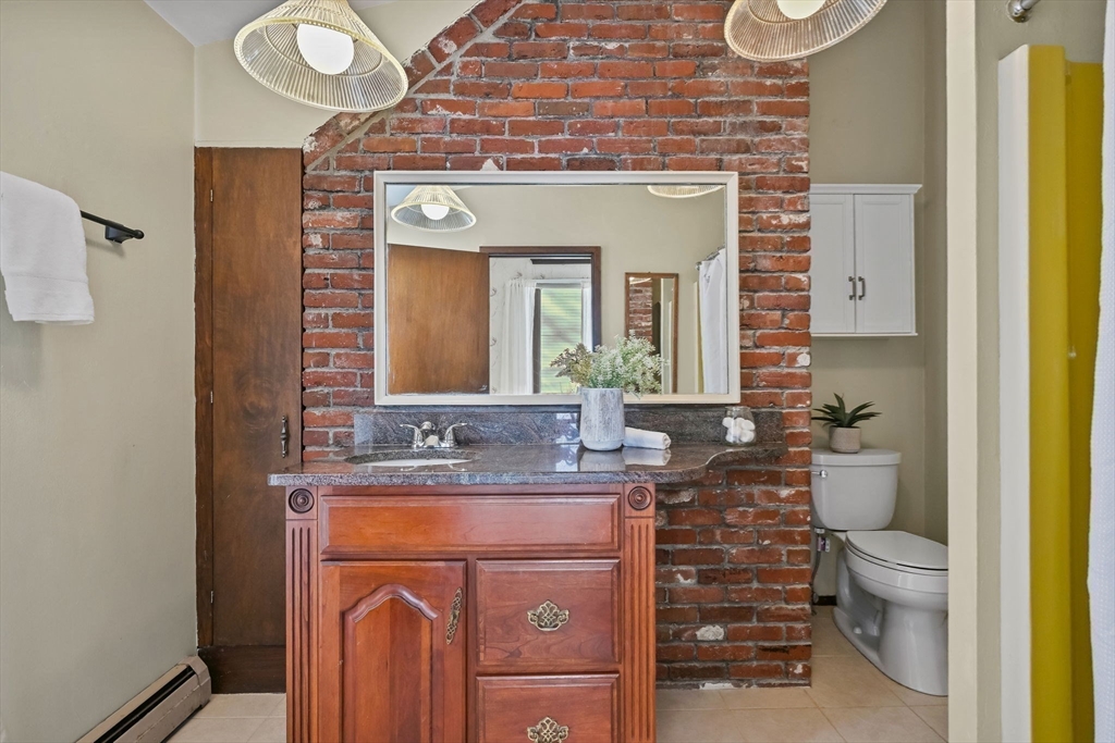 48 Grapevine Avenue Lexington, MA 02421 - Photo 21 of 34 a bathroom with a granite countertop toilet sink and mirror