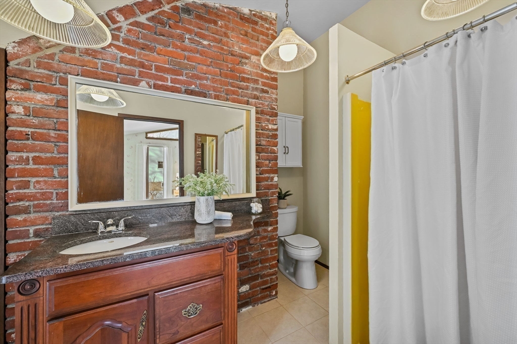48 Grapevine Avenue Lexington, MA 02421 - Photo 22 of 34 a bathroom with a granite countertop sink and a mirror