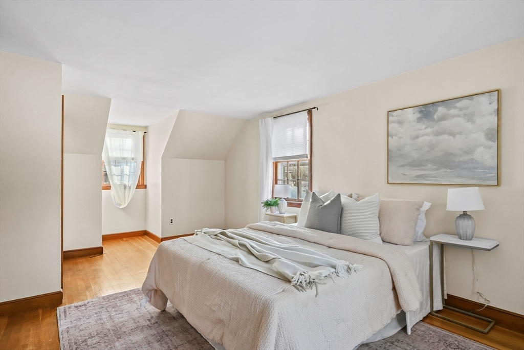 48 Grapevine Avenue Lexington, MA 02421 - Photo 26 of 34 a bedroom with a bed and wooden floor