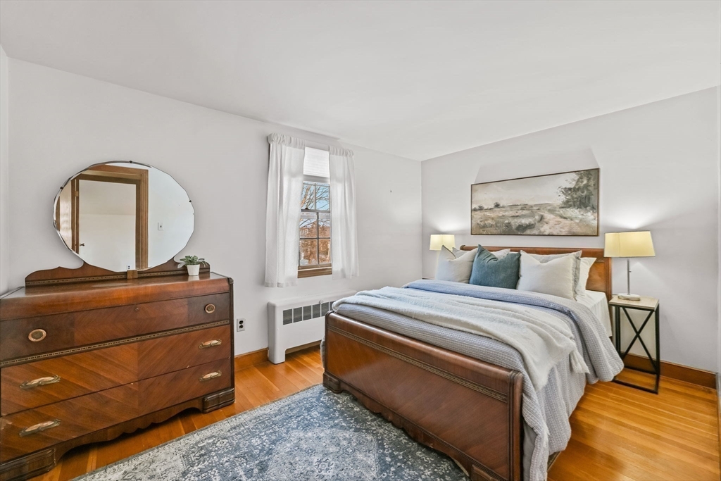 48 Grapevine Avenue Lexington, MA 02421 - Photo 28 of 34 a bed room with a bed and a mirror