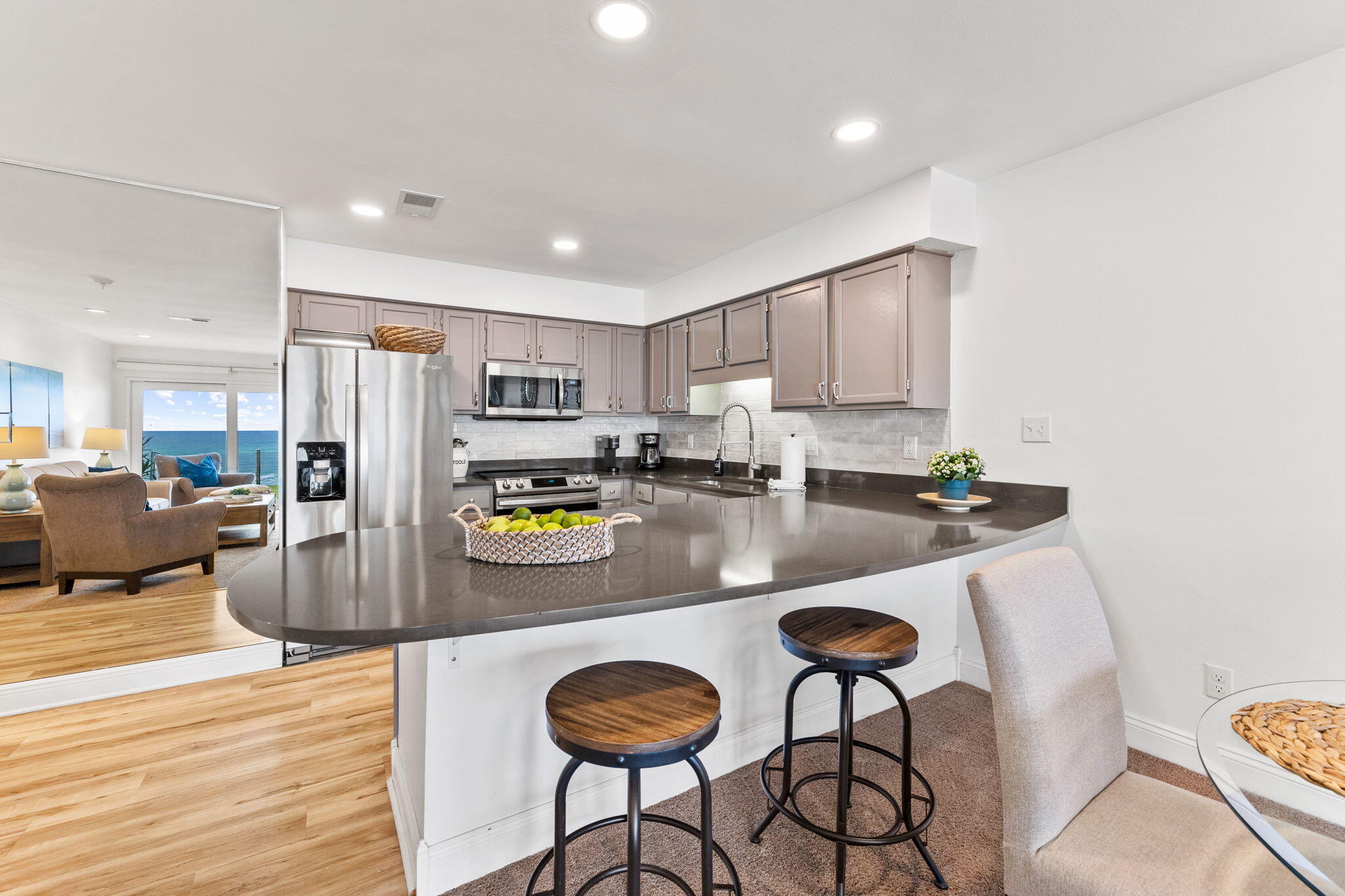 214 Blue Mountain Road, Unit 114 Santa Rosa Beach, FL 32459 - Photo 12 of 39 a kitchen with stainless steel appliances granite countertop a refrigerator a stove a sink a dining table and chairs with wooden floor