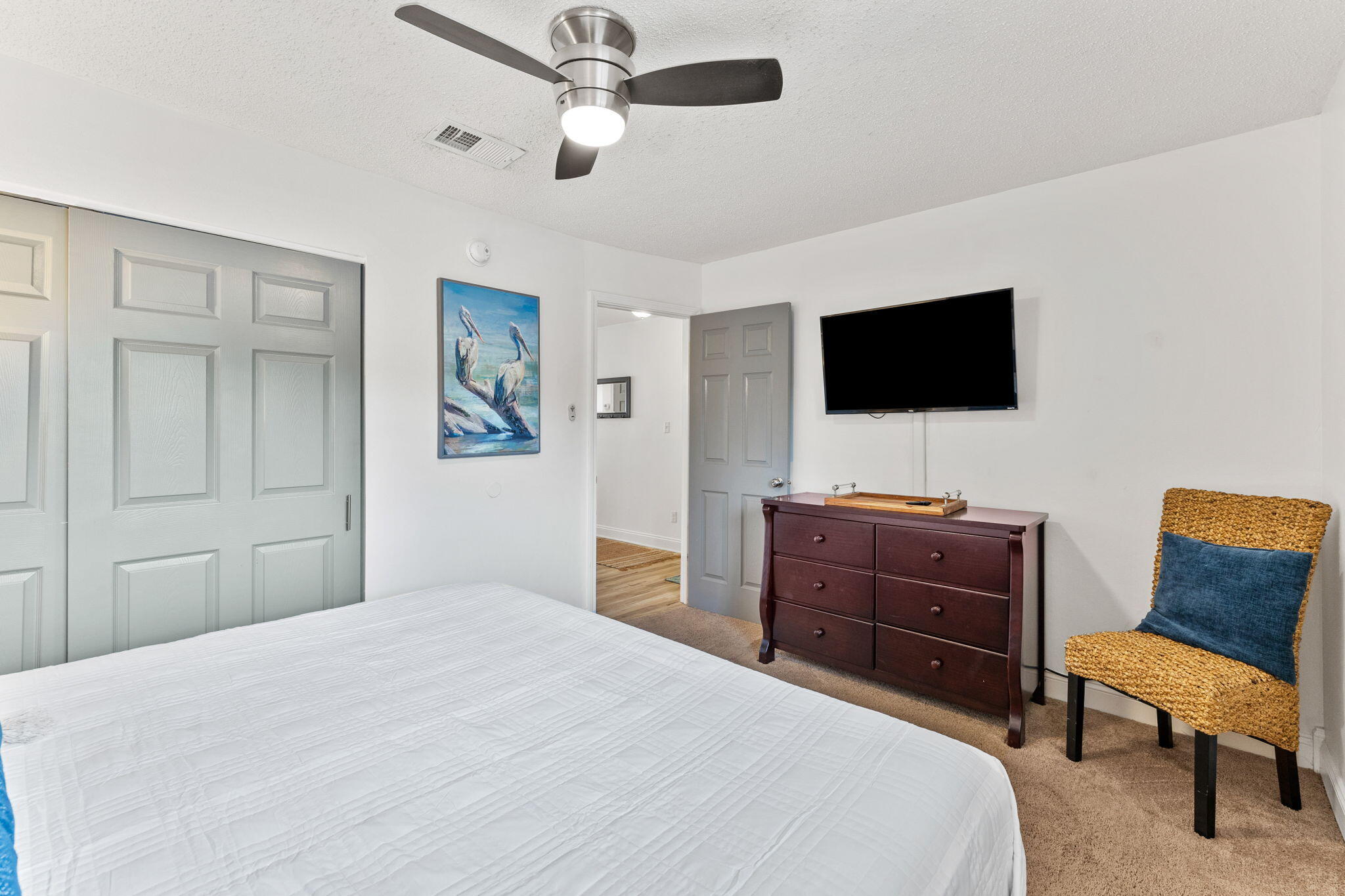 214 Blue Mountain Road, Unit 114 Santa Rosa Beach, FL 32459 - Photo 18 of 39 a bedroom with a bed flat screen tv and a couch