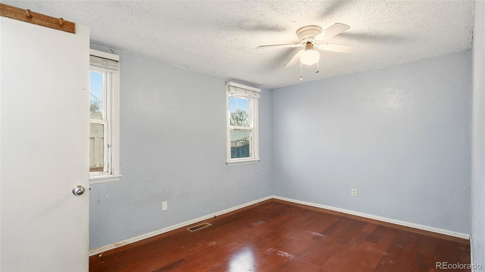 220 State Street Sterling, CO 80751 - Photo 11 of 15 an empty room with a window and a fan