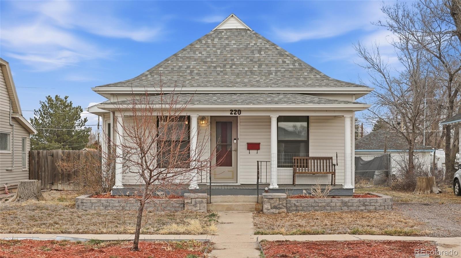 220 State Street Sterling, CO 80751 - Photo 2 of 15 a front view of a house with garden