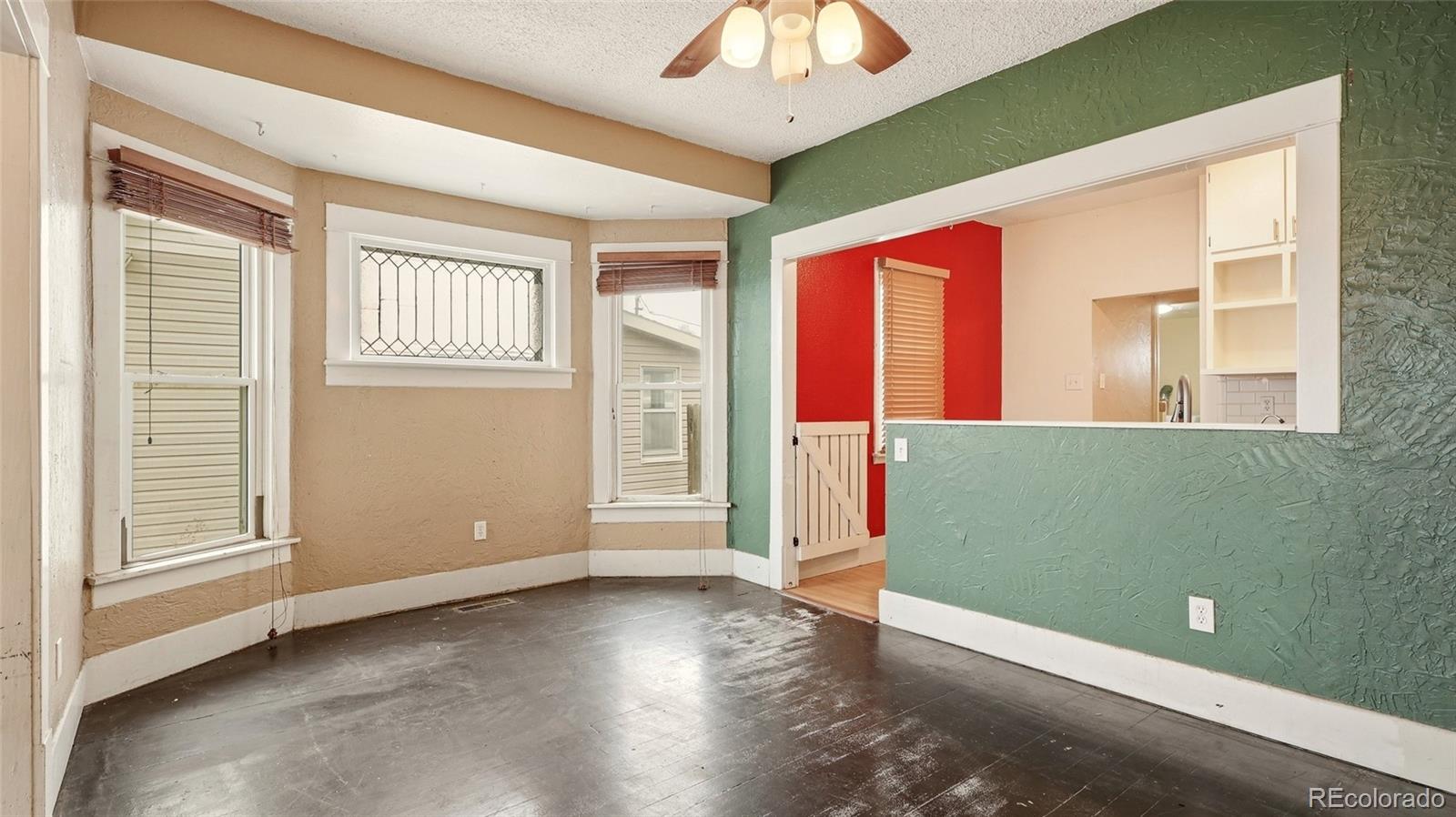 220 State Street Sterling, CO 80751 - Photo 4 of 15 a view of an empty room with a window and wooden floor