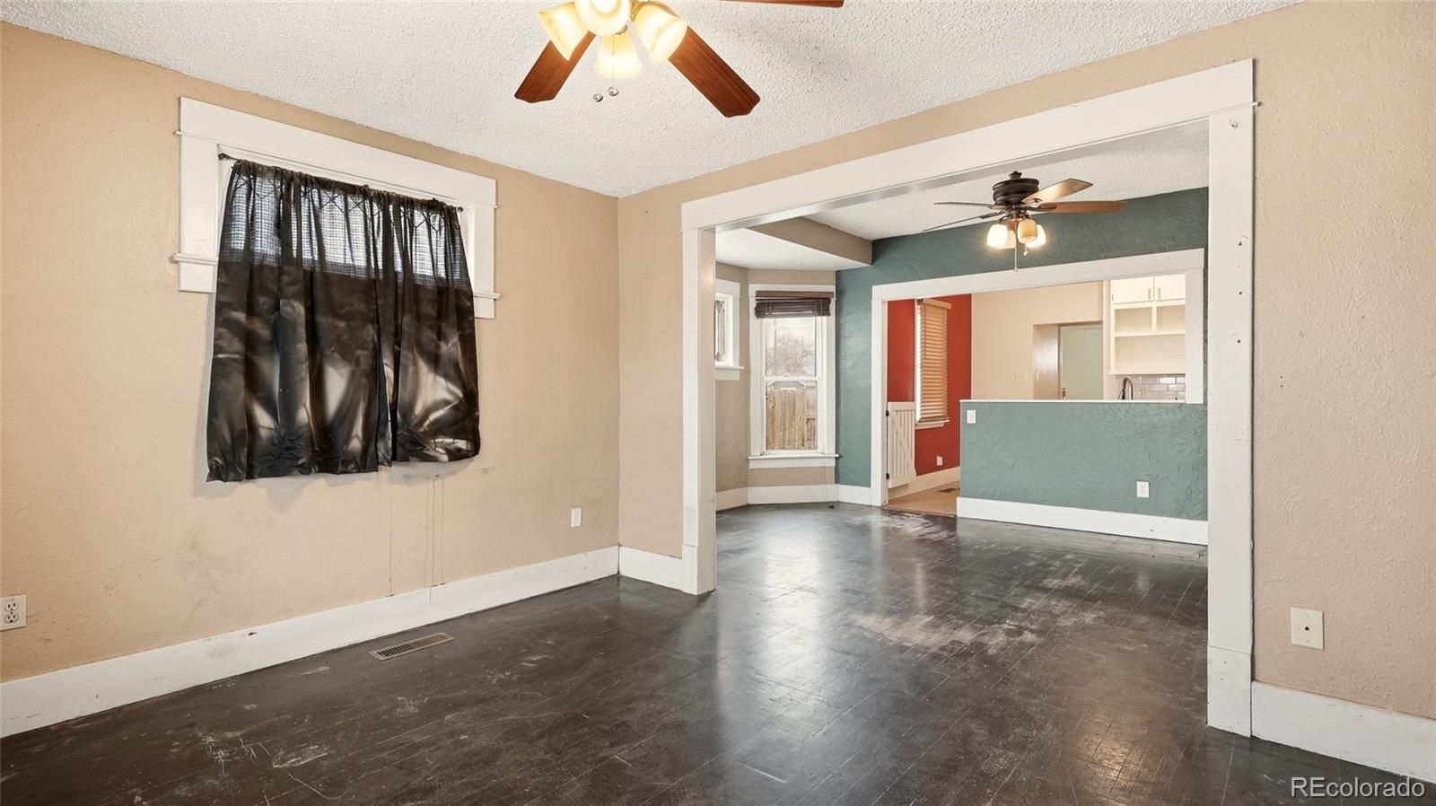 220 State Street Sterling, CO 80751 - Photo 5 of 15 wooden floor in an empty room with a window