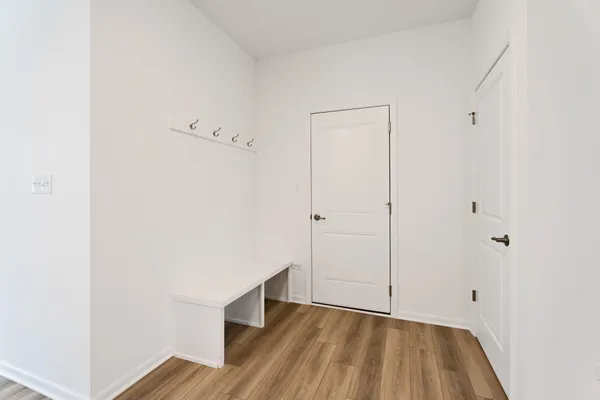 a view of an empty room with wooden floor