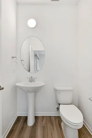 a white toilet sitting next to a bathroom sink