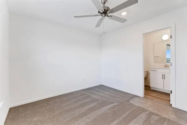 an empty room with a bathroom and a shower