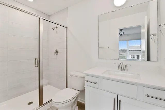 a bathroom with a sink toilet and shower