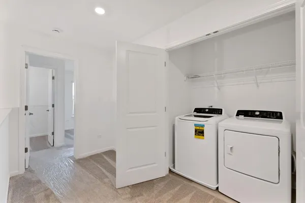 a view of storage and utility room with washer and dryer