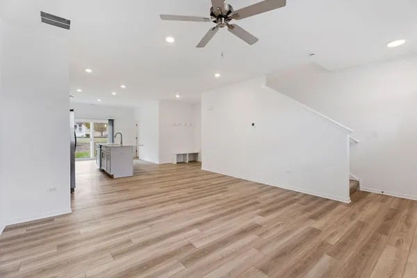 a view of empty room with wooden floor
