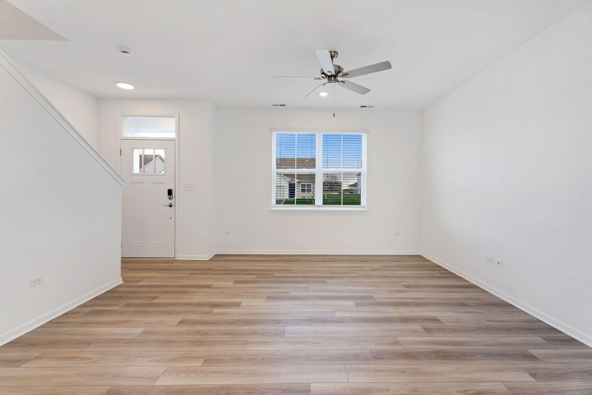 471 East 127th Place Crown Point, IN 46307 - Photo 6 of 27 a view of an empty room with a window and wooden floor