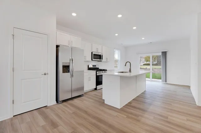 a kitchen with stainless steel appliances a refrigerator and a stove top oven