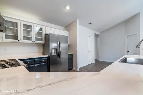 a kitchen with stainless steel appliances granite countertop a refrigerator and a sink