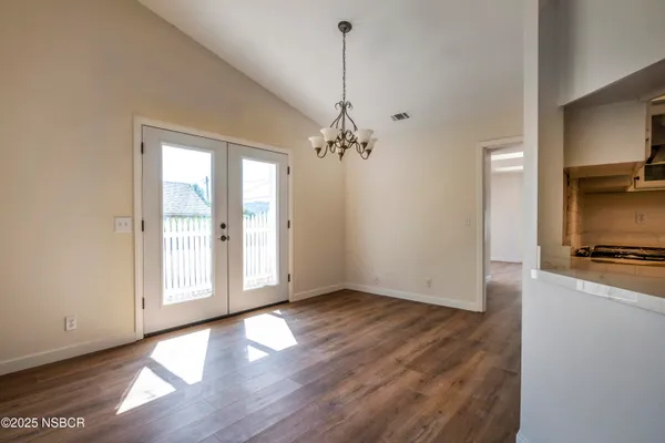 a view of a kitchen with a sink wooden floor and a window
