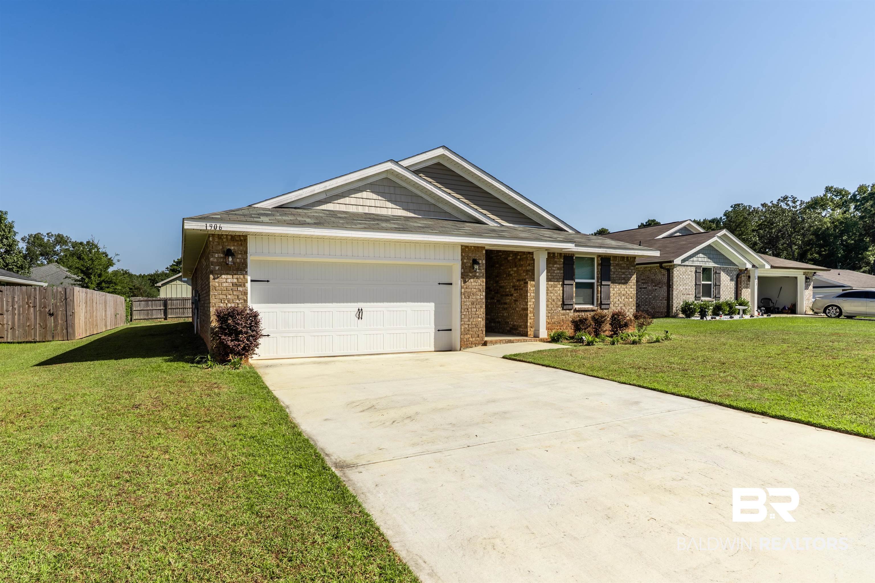 1906 Stonepine Drive South Semmes, AL 36575 - Photo 28 of 30 View of front of home with concrete driveway, an attached garage, and brick siding