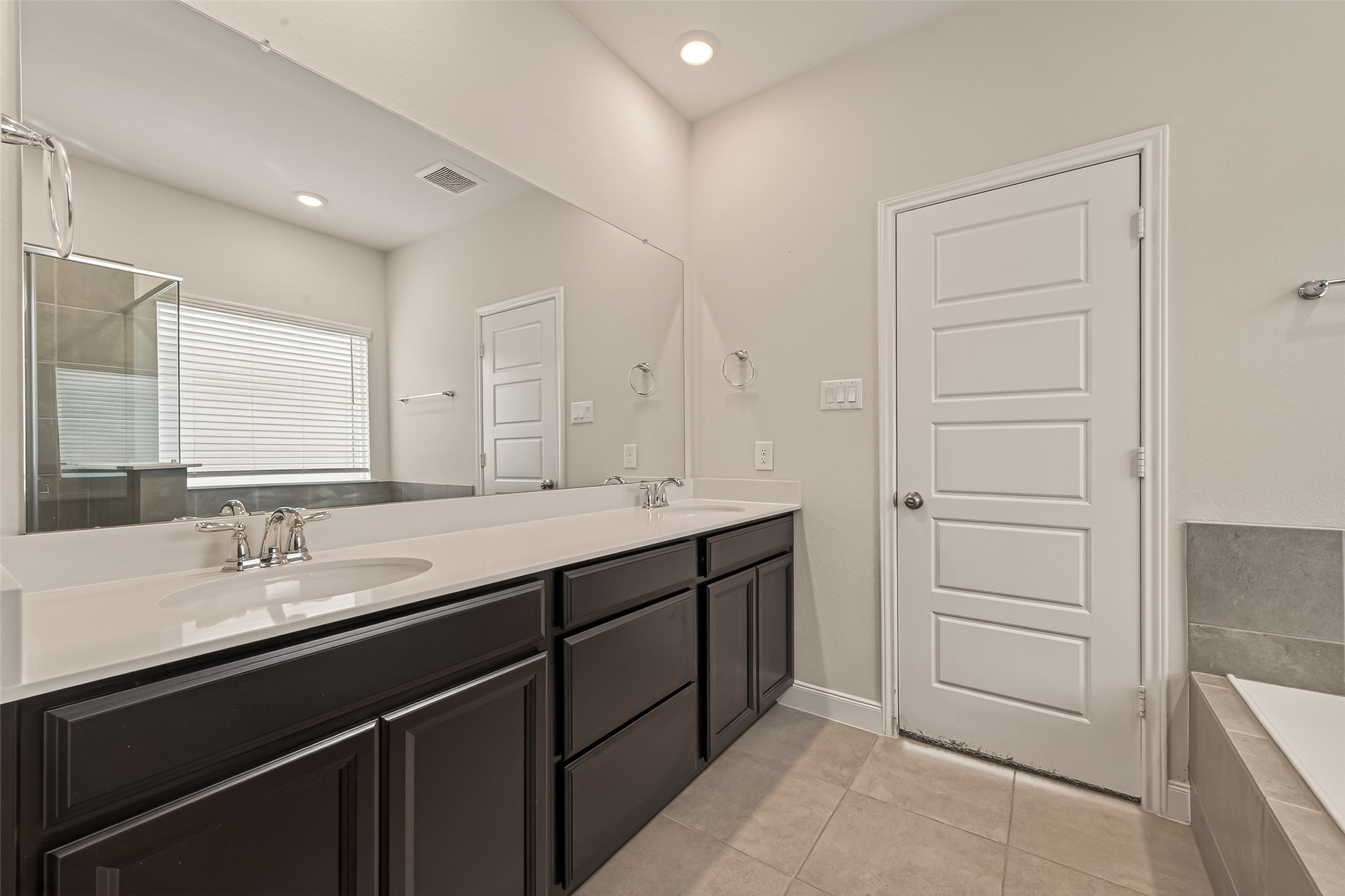 4231 Reese Ravine Lane Katy, TX 77493 - Photo 13 of 32 Espresso colored cabinets and sleek silver fixtures complete this room nicely