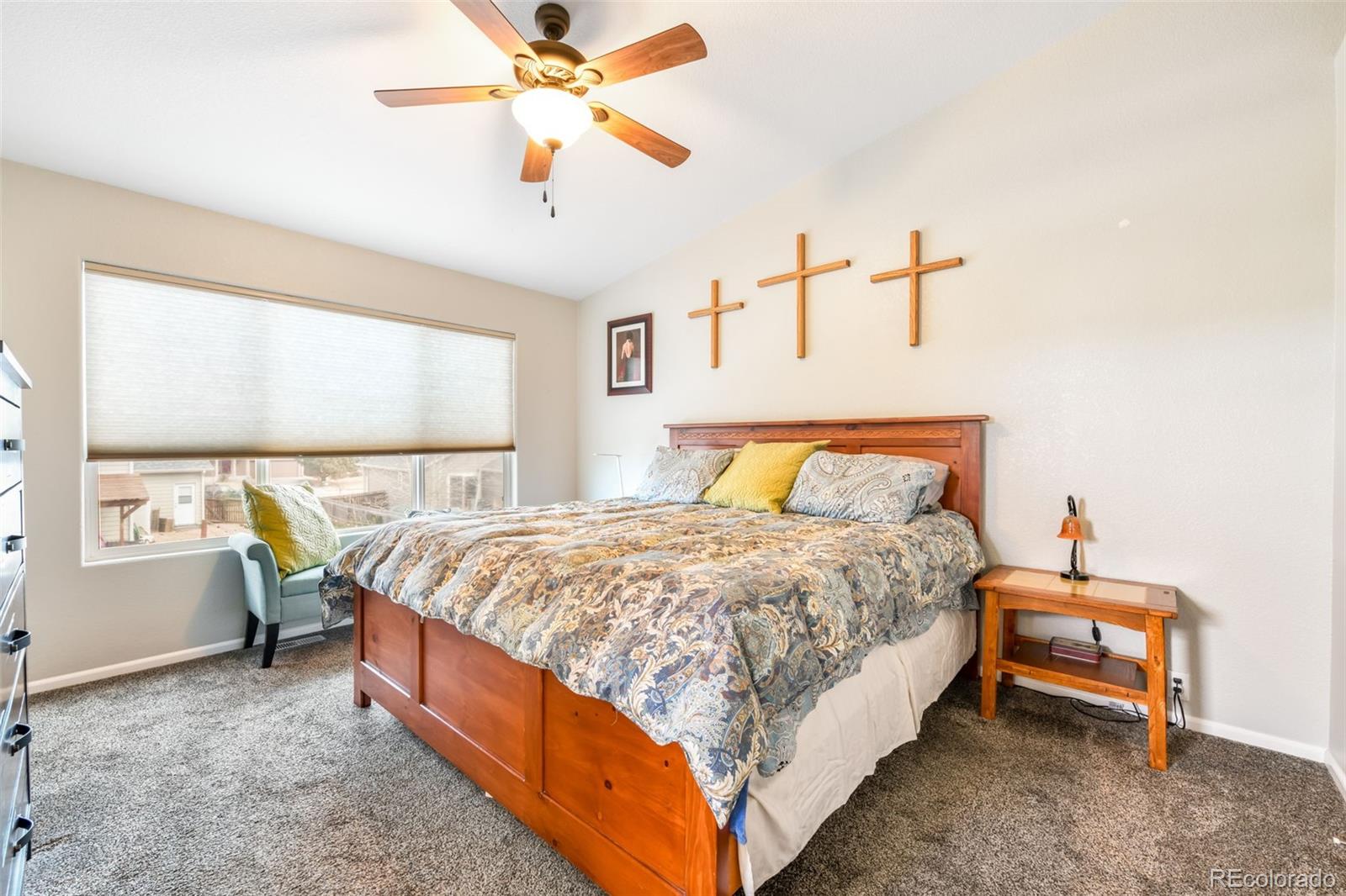 12906 Oakland Hills Road Peyton, CO 80831 - Photo 11 of 50 a bed room with a bed and a chandelier