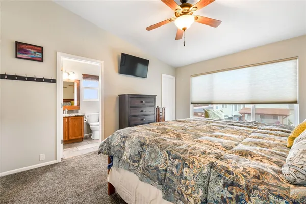 a spacious bedroom with a bed and a chandelier