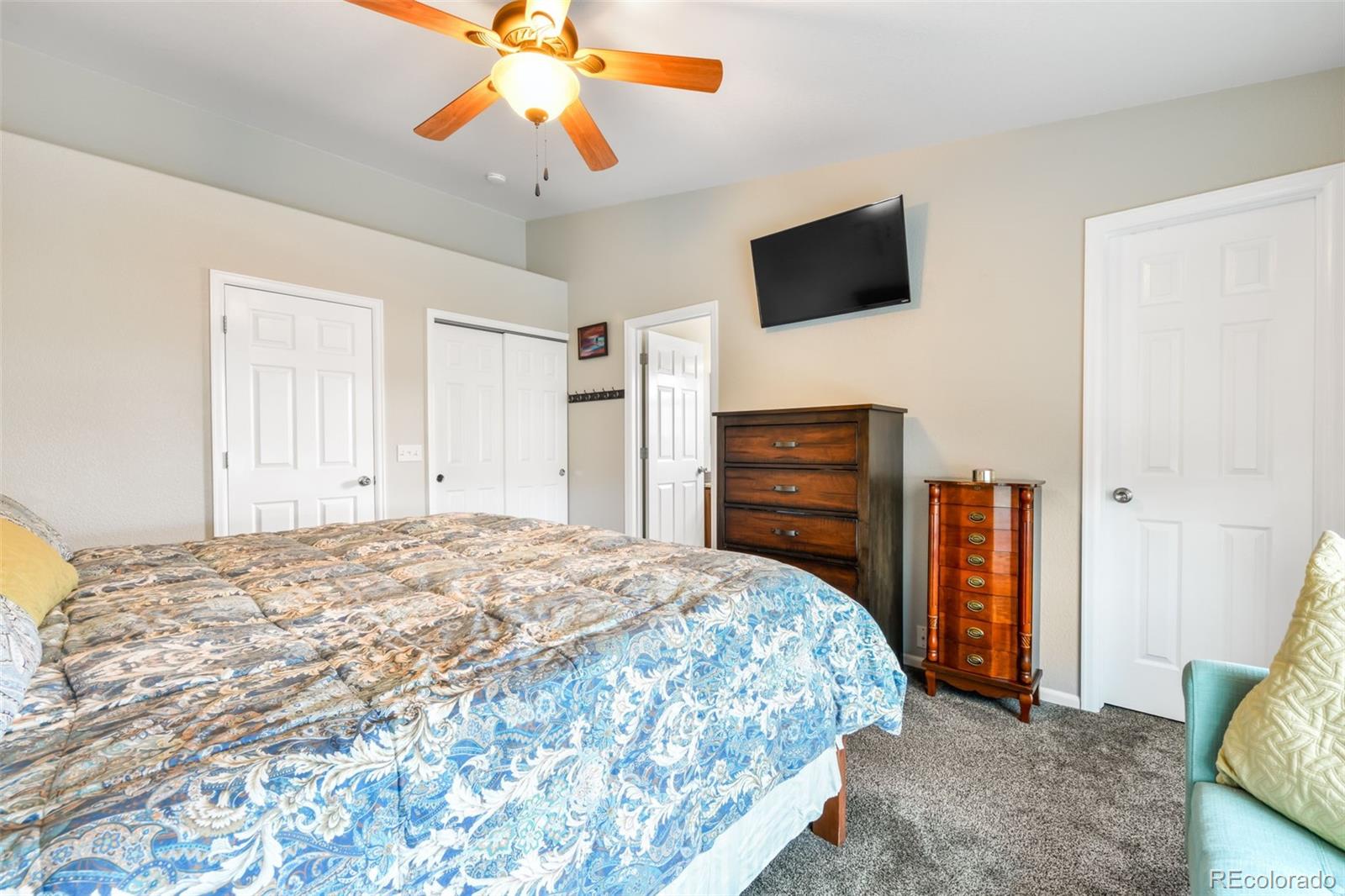 12906 Oakland Hills Road Peyton, CO 80831 - Photo 13 of 50 a bedroom with a bed and a flat screen tv