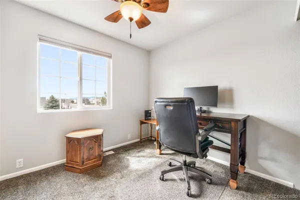 a view of workspace with wooden floor windows