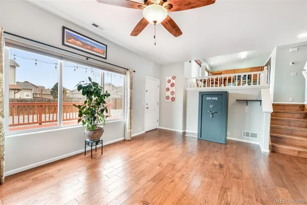 wooden floor in an empty room with a window