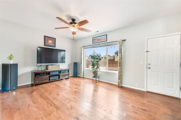 a view of a livingroom with furniture window and wooden floor