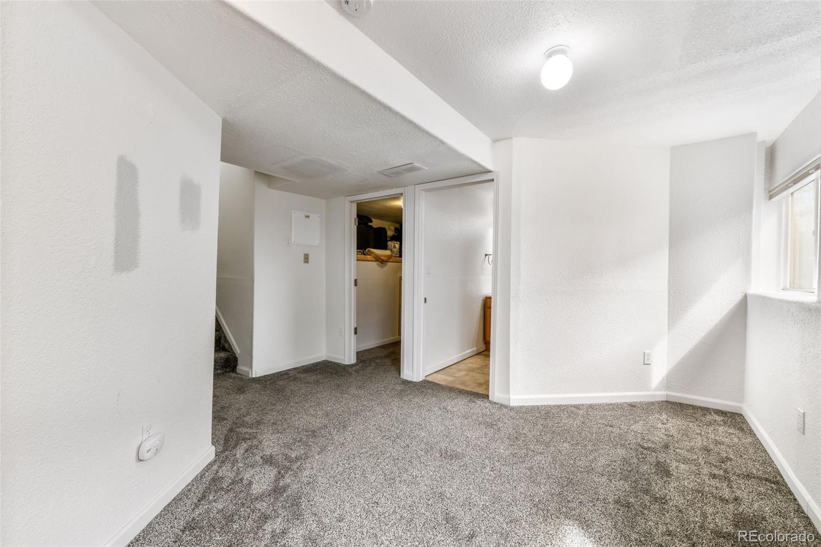 12906 Oakland Hills Road Peyton, CO 80831 - Photo 27 of 50 an empty room with a natural light