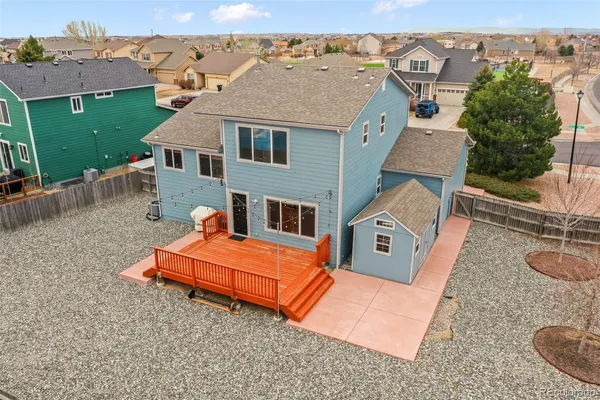an aerial view of a house with swimming pool and mountains