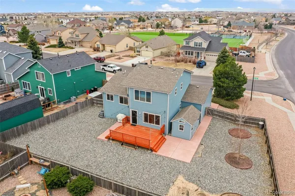 an aerial view of a house with a yard