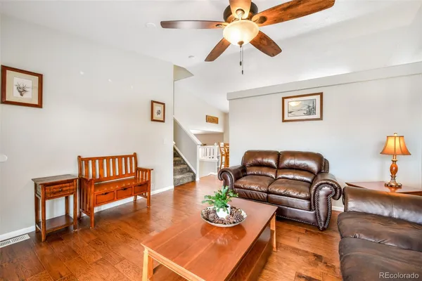 a living room with furniture and wooden floor