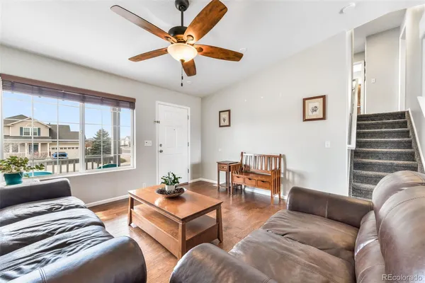 a bedroom with furniture and a large window