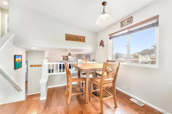 a view of a dining room with furniture window and wooden floor