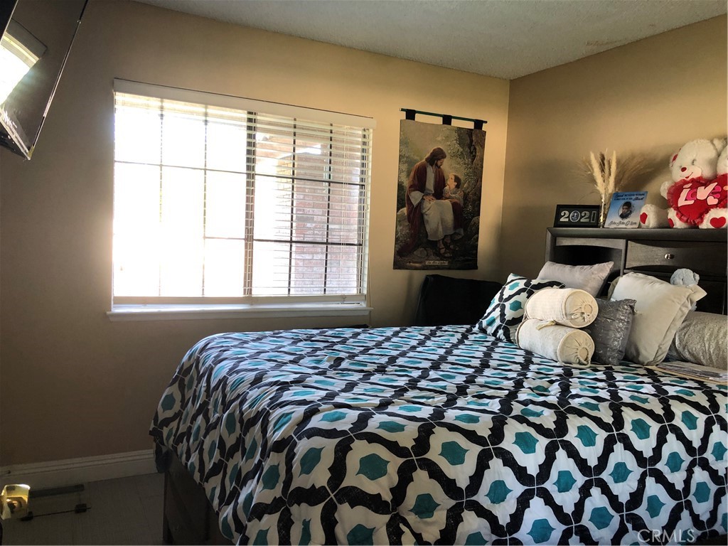 8864 Haskell Street Riverside, CA 92503 - Photo 11 of 18 a bedroom with a bed and walk in closet