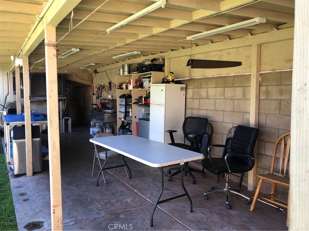 8864 Haskell Street Riverside, CA 92503 - Photo 13 of 18 a view of a workspace with furniture and a potted plant