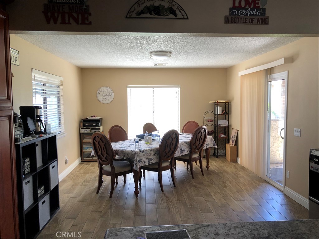 8864 Haskell Street Riverside, CA 92503 - Photo 5 of 18 a view of a a dining room with furniture window and wooden floor
