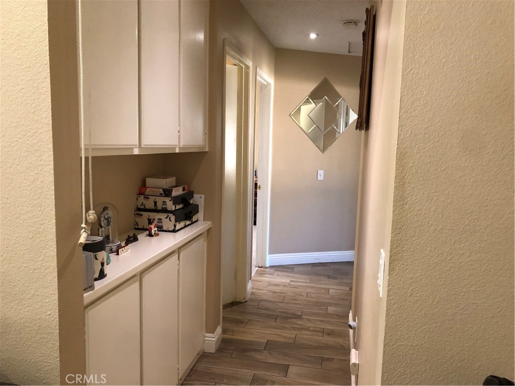 8864 Haskell Street Riverside, CA 92503 - Photo 6 of 18 a kitchen with white cabinets and a sink