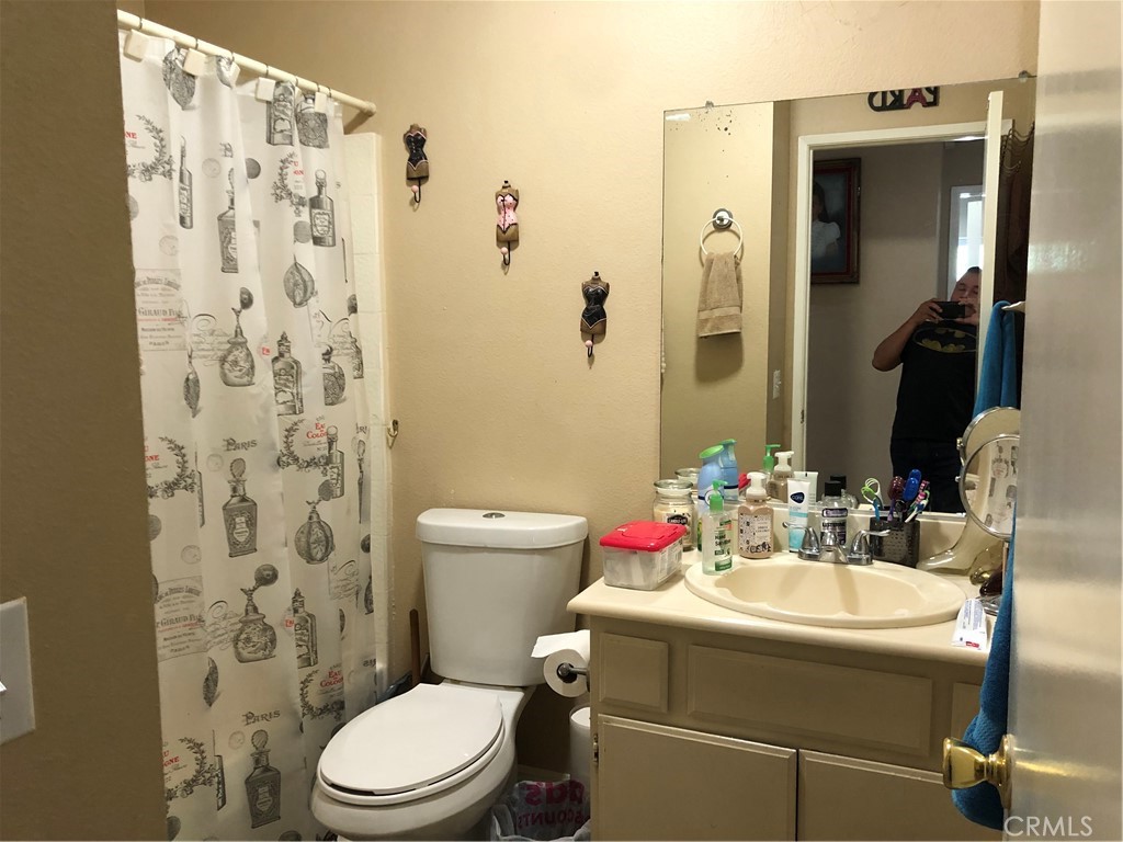 8864 Haskell Street Riverside, CA 92503 - Photo 7 of 18 a bathroom with a toilet and a sink