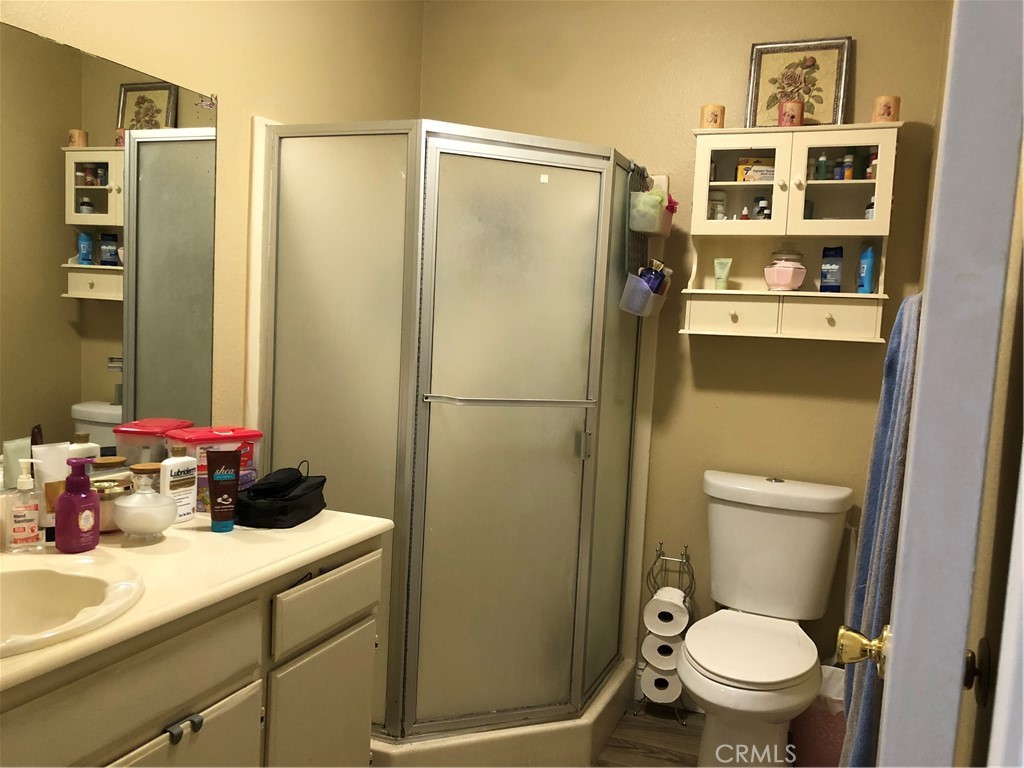 8864 Haskell Street Riverside, CA 92503 - Photo 9 of 18 a bathroom with a sink a toilet and shower