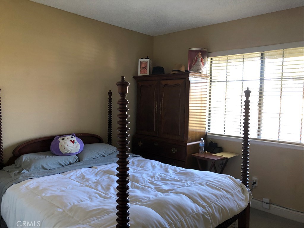 8864 Haskell Street Riverside, CA 92503 - Photo 10 of 18 a bedroom with a bed and a window