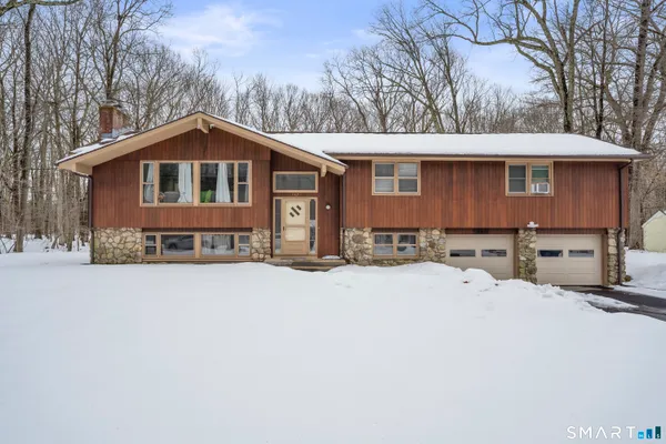 a front view of a house with yard covered in snow