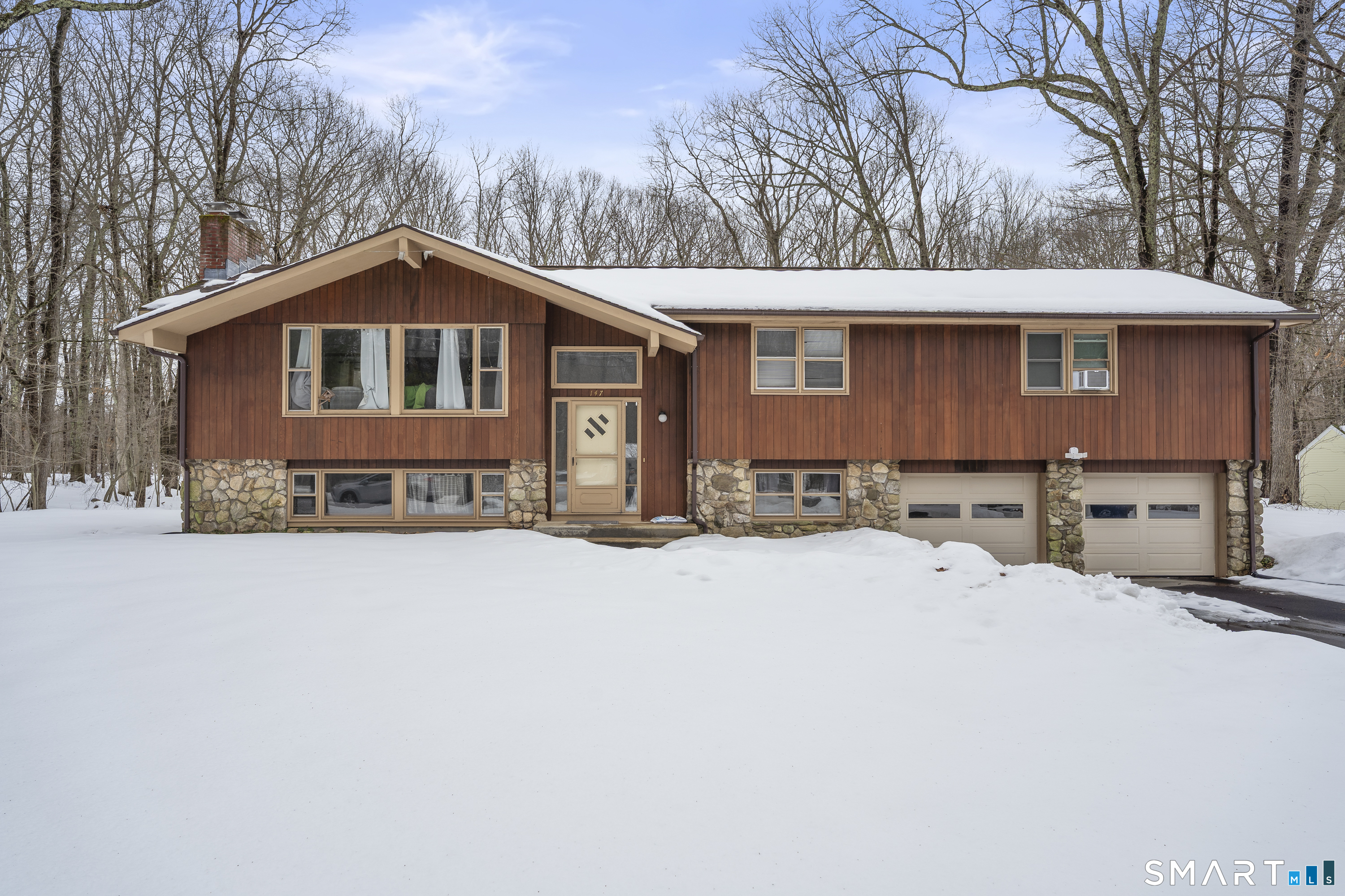 147 Davis Road Mansfield, CT 06268 - Photo 1 of 1 a front view of a house with yard covered in snow