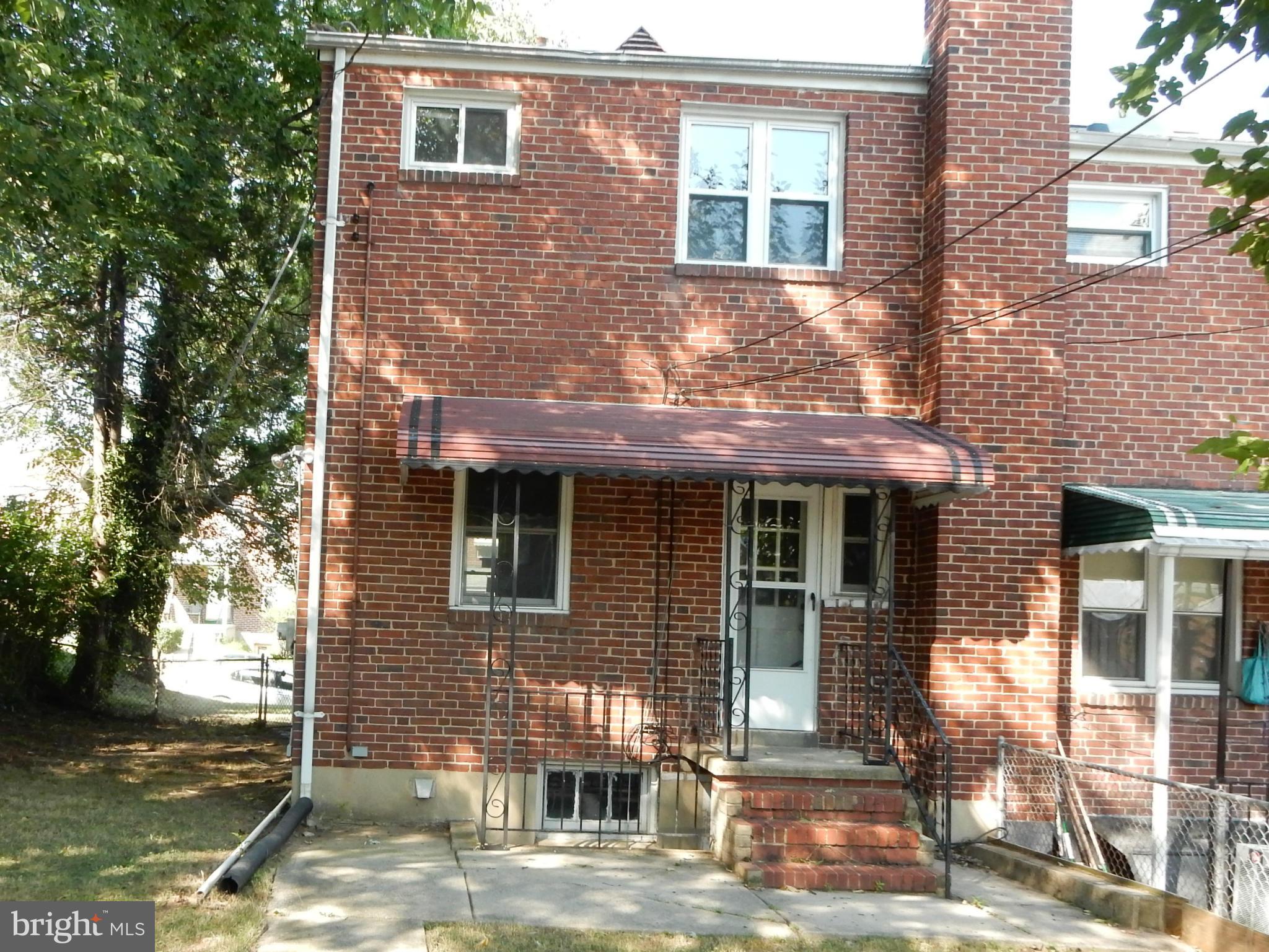 1817 Swansea Road Baltimore, MD 21239 - Photo 2 of 8 a front view of a house with a yard