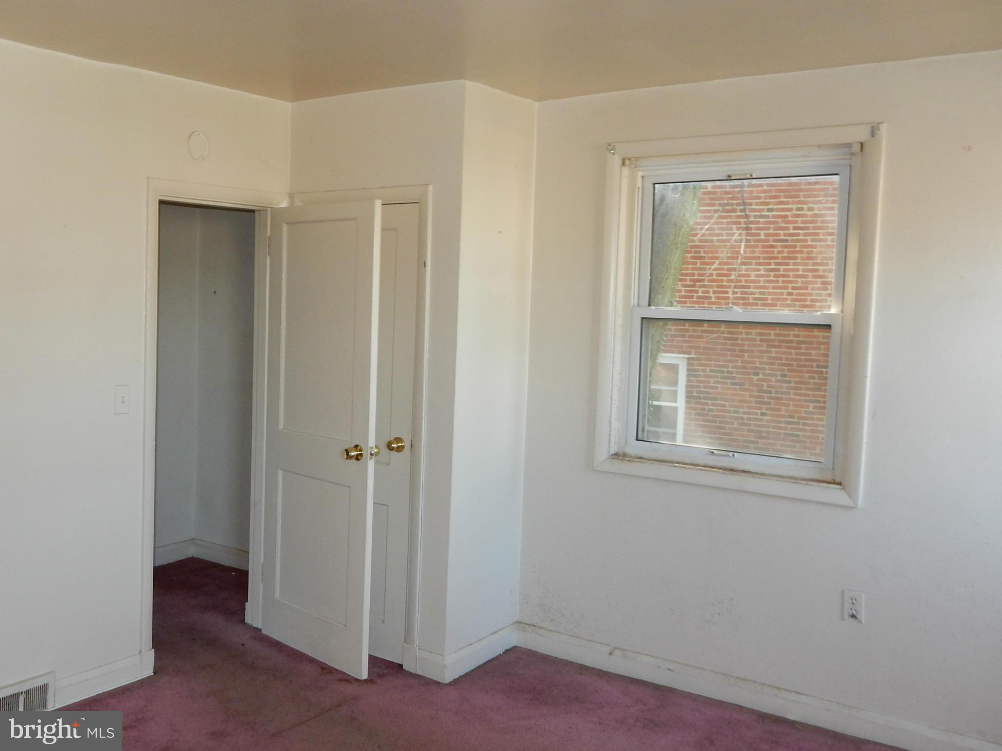1817 Swansea Road Baltimore, MD 21239 - Photo 6 of 8 an empty room with windows and closet