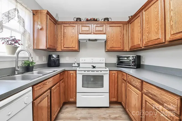 a kitchen with stainless steel appliances granite countertop a sink and cabinets