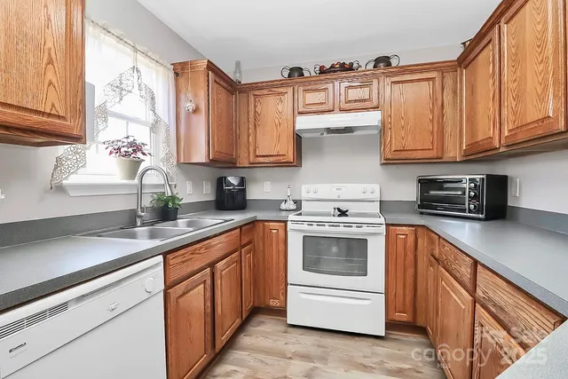 a kitchen with stainless steel appliances granite countertop a sink and cabinets