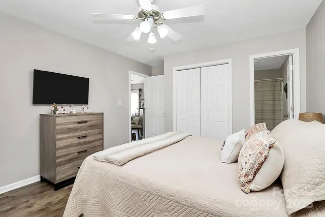 a bedroom with a bed and a flat screen tv
